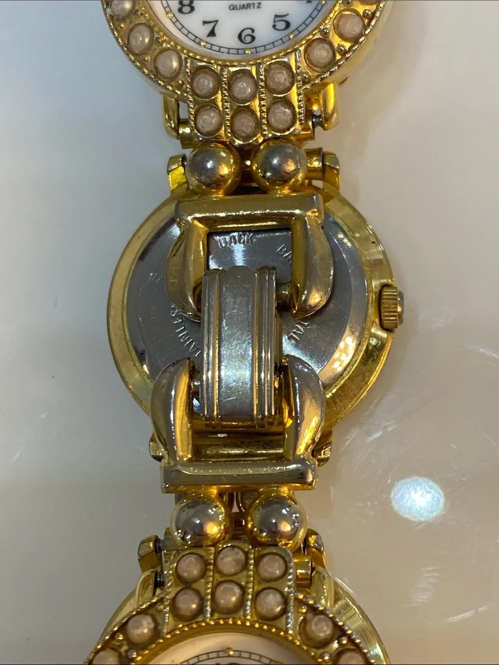 Faux pearl gold tone watch